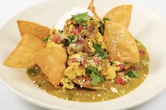 Green chilaquiles with carnitas and eggs