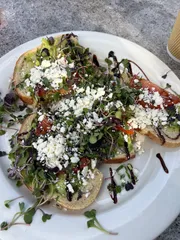 Forked avocado & herbs on toast